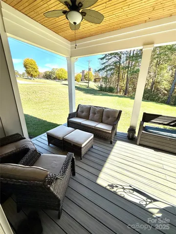 a living room with furniture and a floor to ceiling window