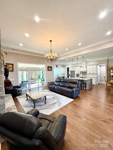 a living room with furniture and a chandelier