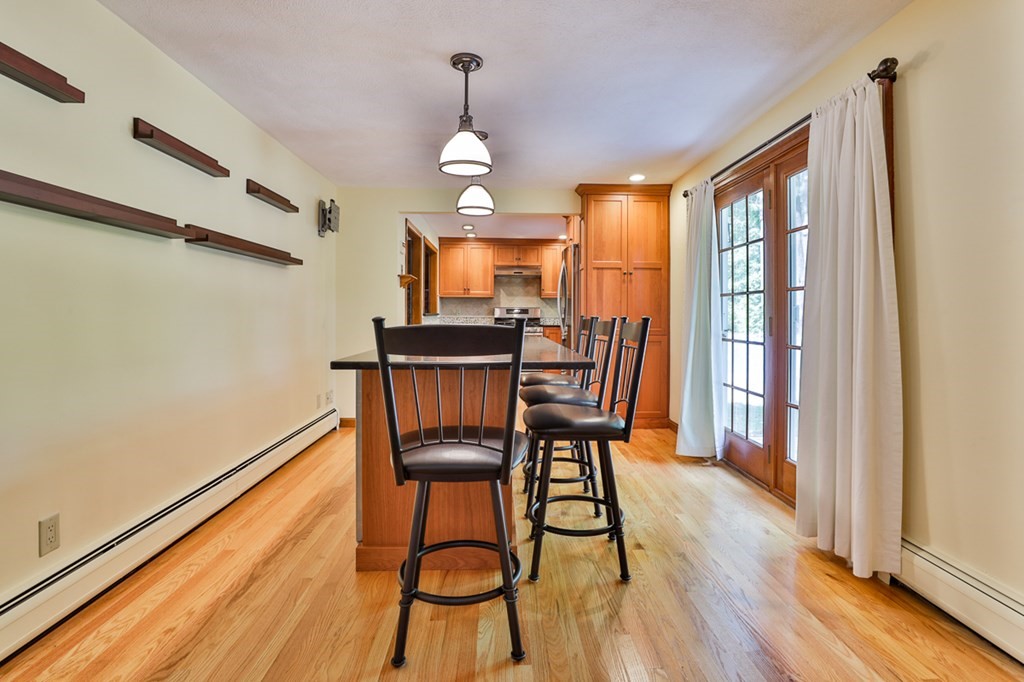 9 Handel Road Billerica, MA 01821 - Photo 13 of 40 a dining room with furniture a chandelier and wooden floor