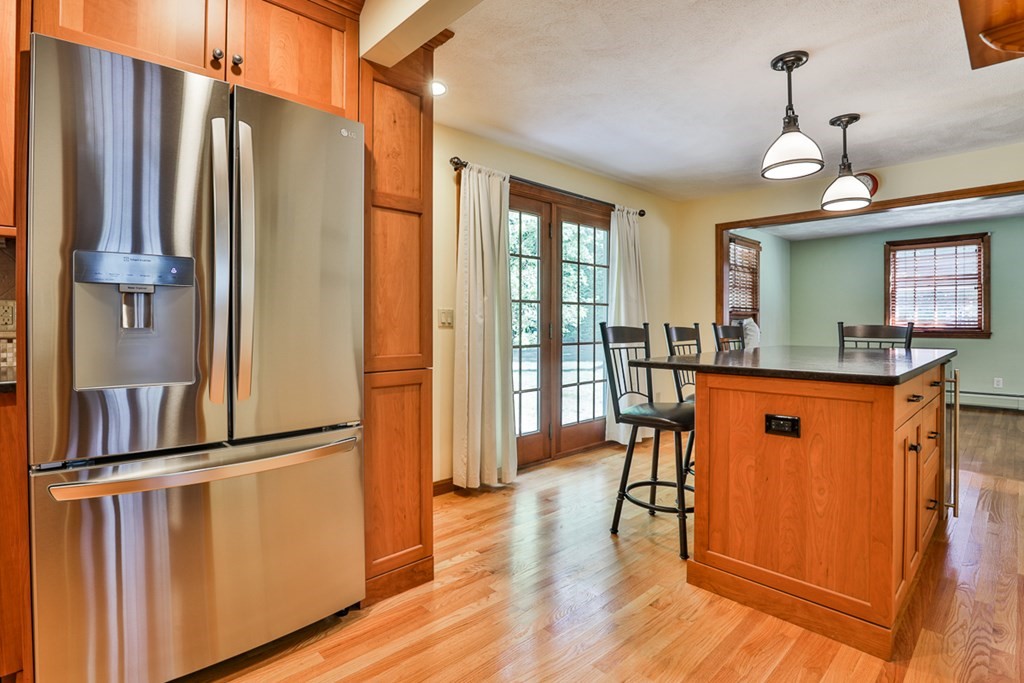 9 Handel Road Billerica, MA 01821 - Photo 16 of 40 a dining room with stainless steel appliances granite countertop a refrigerator a stove a sink and dishwasher with wooden floor