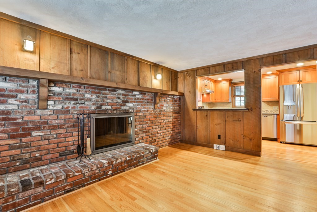 9 Handel Road Billerica, MA 01821 - Photo 23 of 40 a view of a livingroom with wooden floor and a fireplace