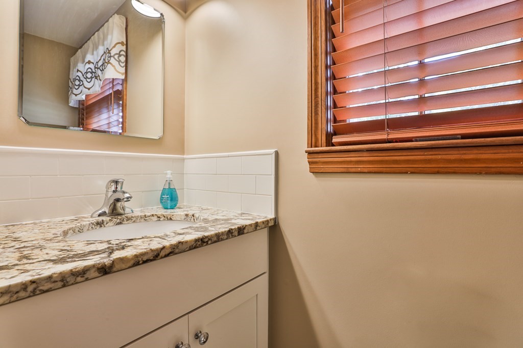 9 Handel Road Billerica, MA 01821 - Photo 25 of 40 a bathroom with a granite countertop sink and a mirror