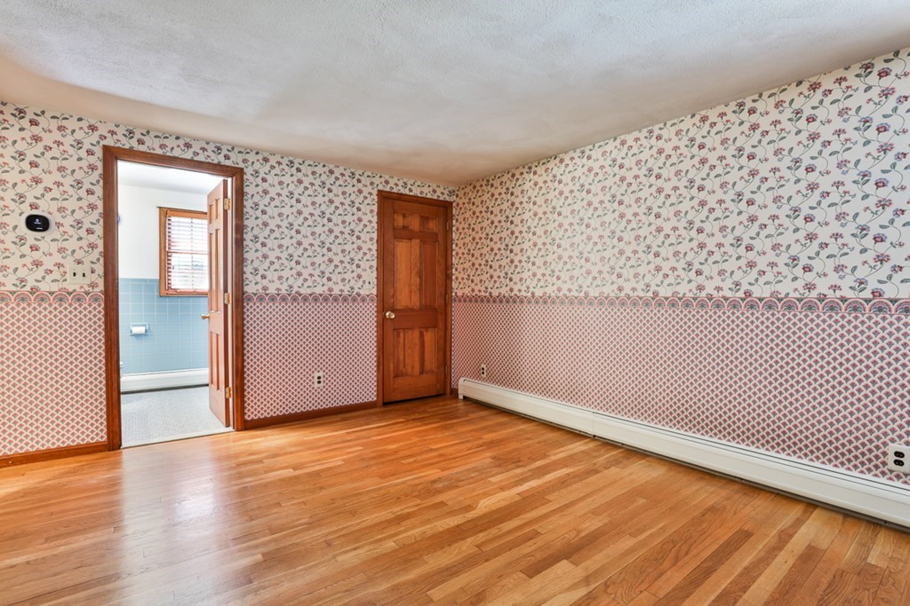 9 Handel Road Billerica, MA 01821 - Photo 30 of 40 an empty room with wooden floor and windows