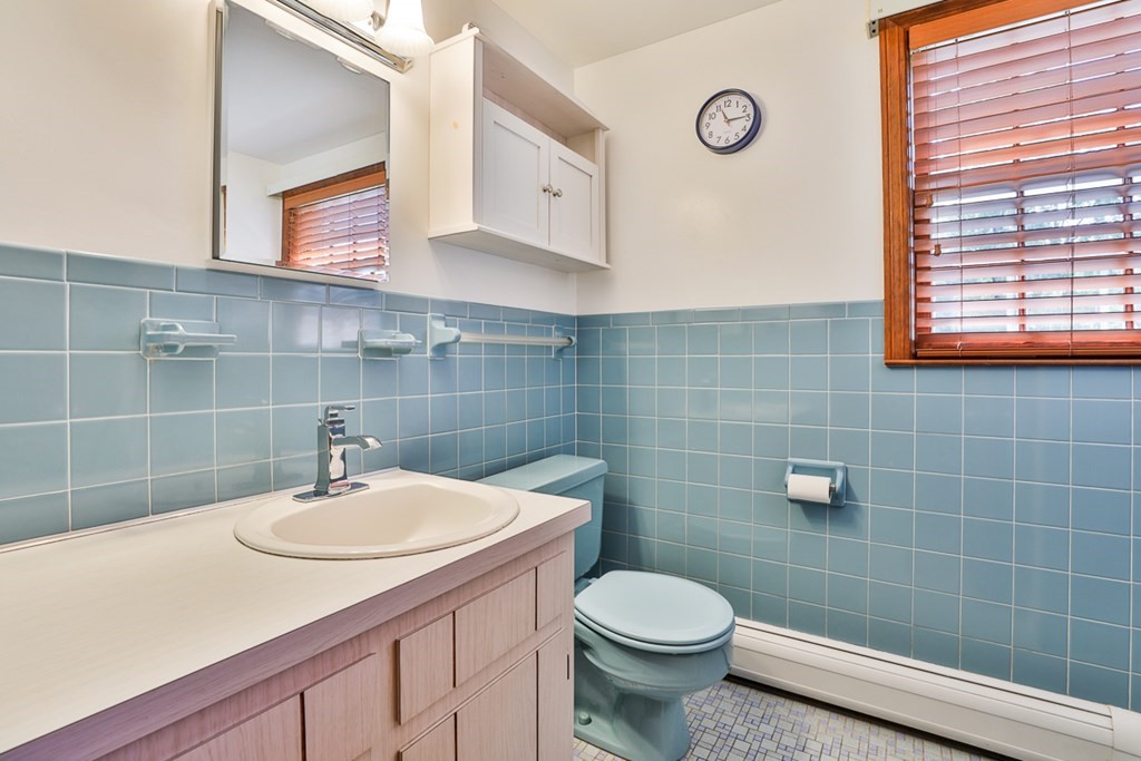 9 Handel Road Billerica, MA 01821 - Photo 32 of 40 a bathroom with a sink a toilet and mirror