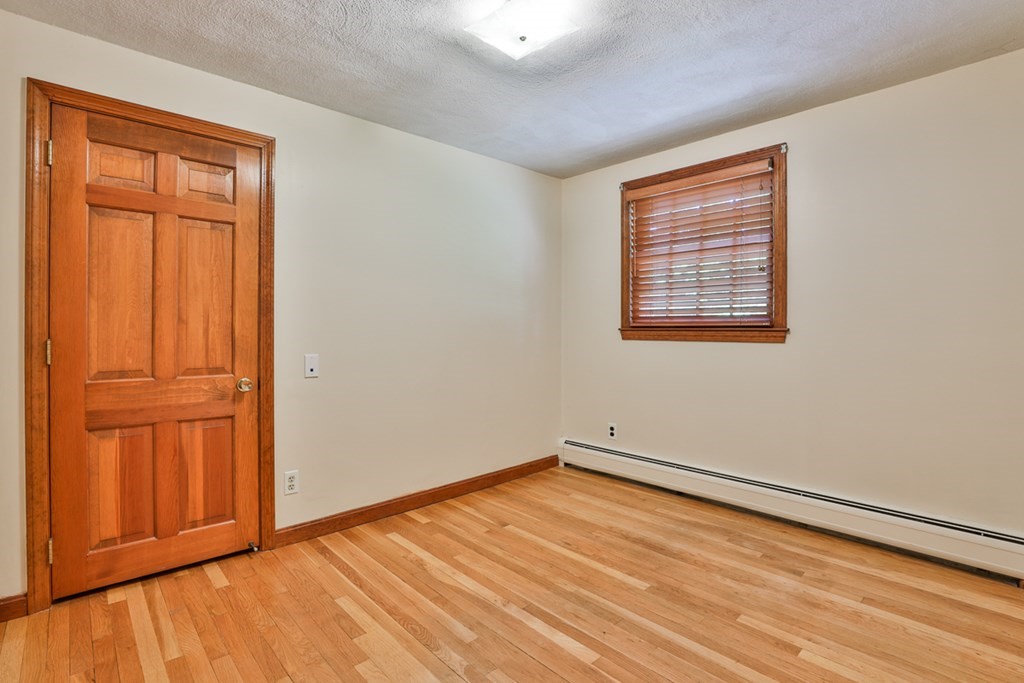 9 Handel Road Billerica, MA 01821 - Photo 39 of 40 an empty room with wooden floor and windows