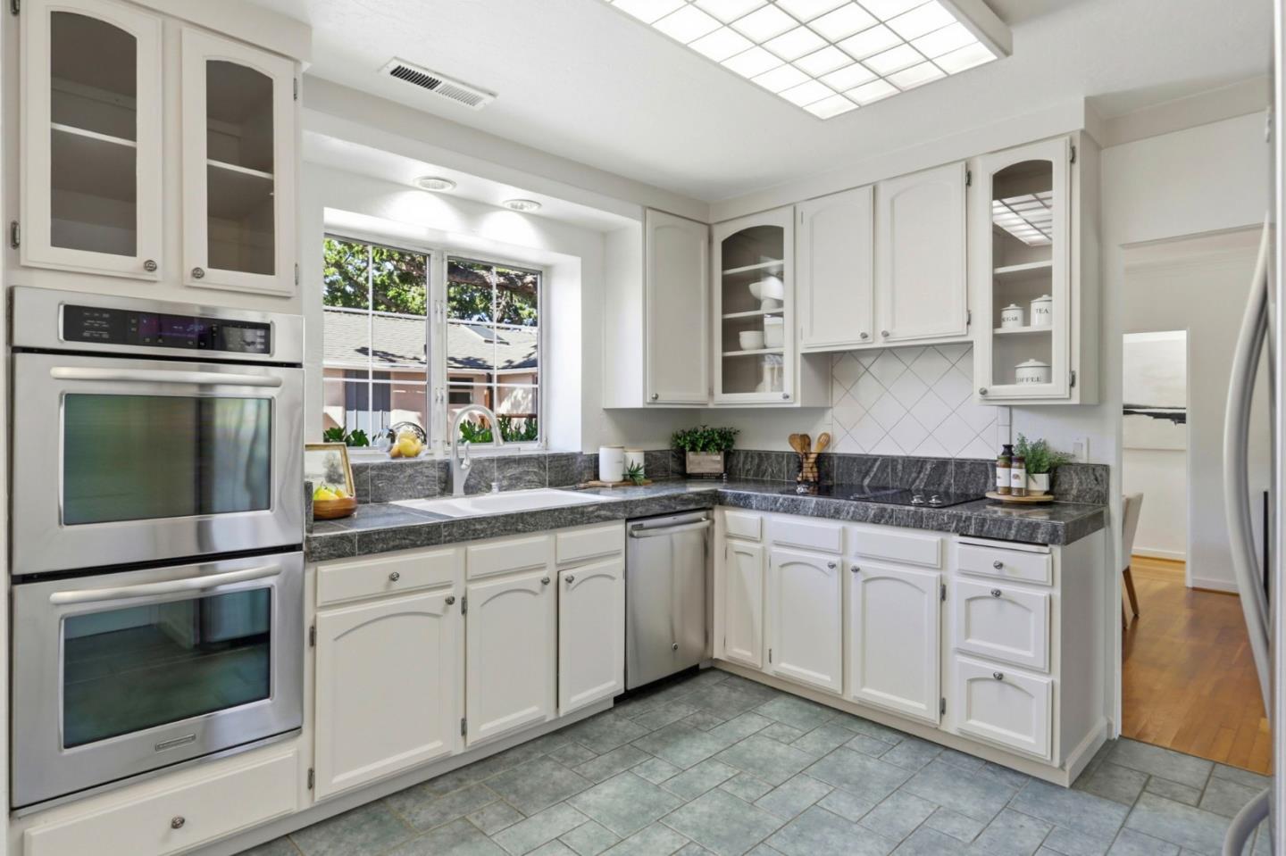 20360 Orchard Road Saratoga, CA 95070 - Photo 13 of 43 a kitchen with white cabinets and sink