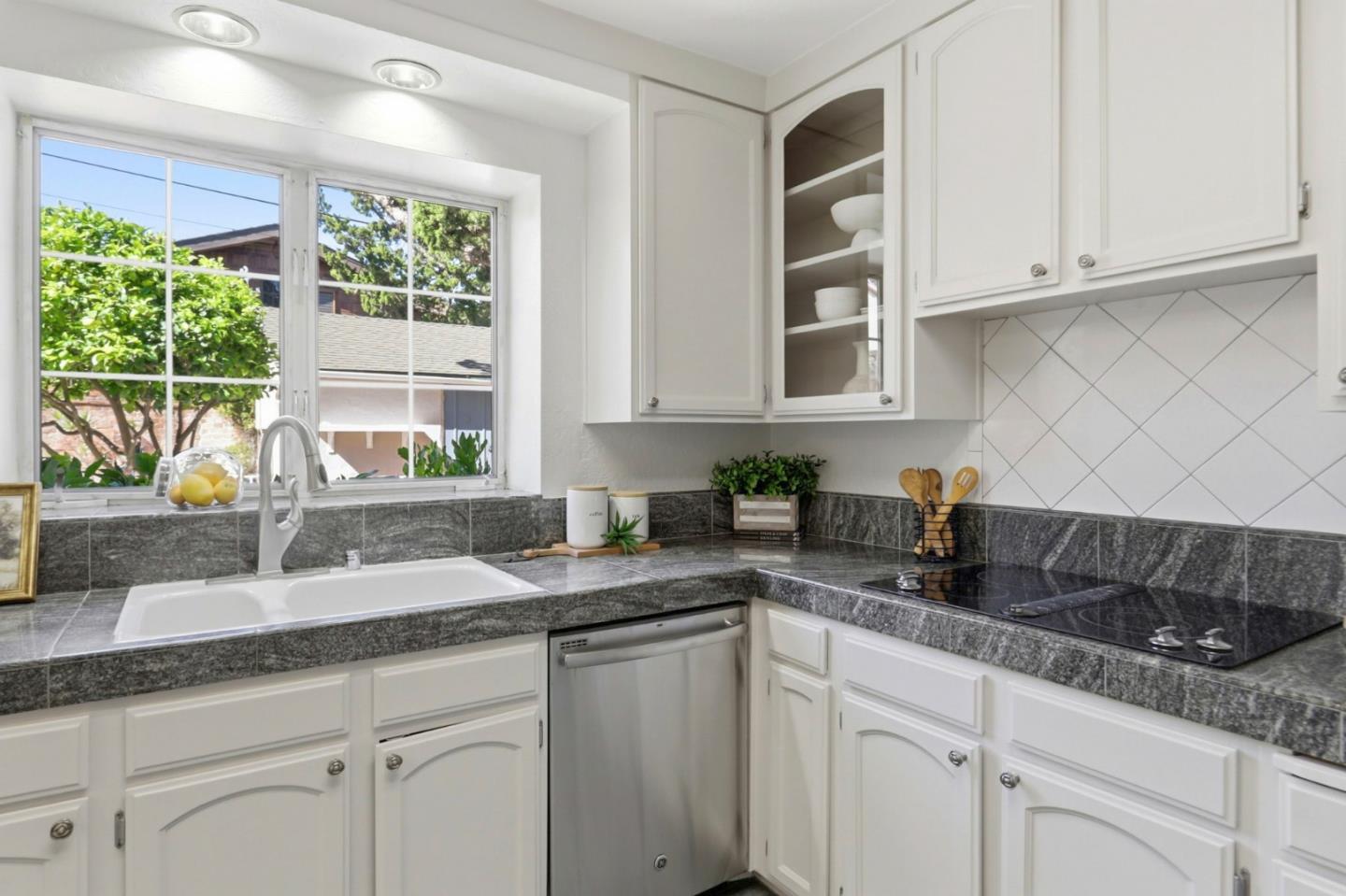 20360 Orchard Road Saratoga, CA 95070 - Photo 14 of 43 a kitchen with granite countertop a sink white cabinets and window