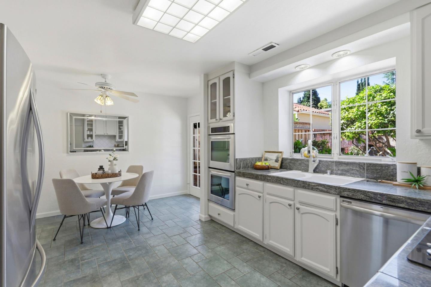 20360 Orchard Road Saratoga, CA 95070 - Photo 15 of 43 a kitchen with a sink cabinets and window