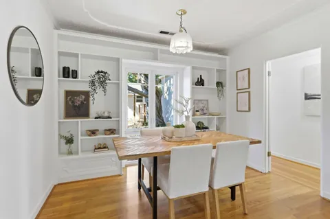 a bedroom with a bed and glass window