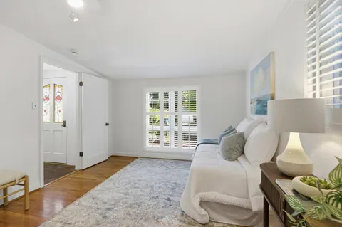 a bedroom with bed and window