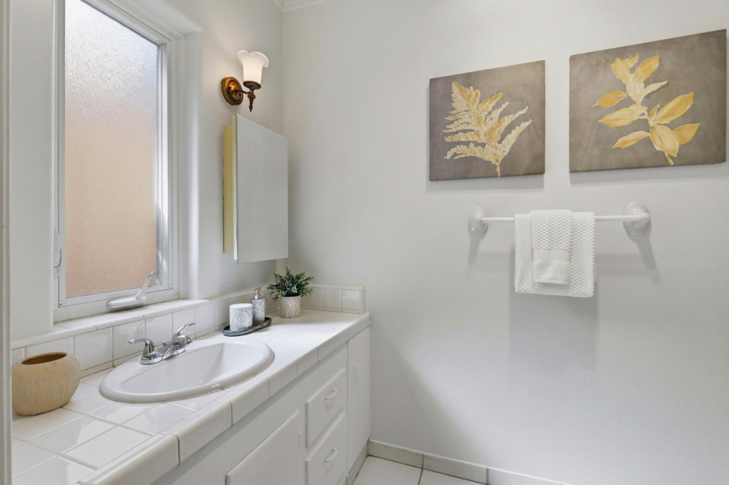 20360 Orchard Road Saratoga, CA 95070 - Photo 22 of 43 a bathroom with a granite countertop sink and a mirror