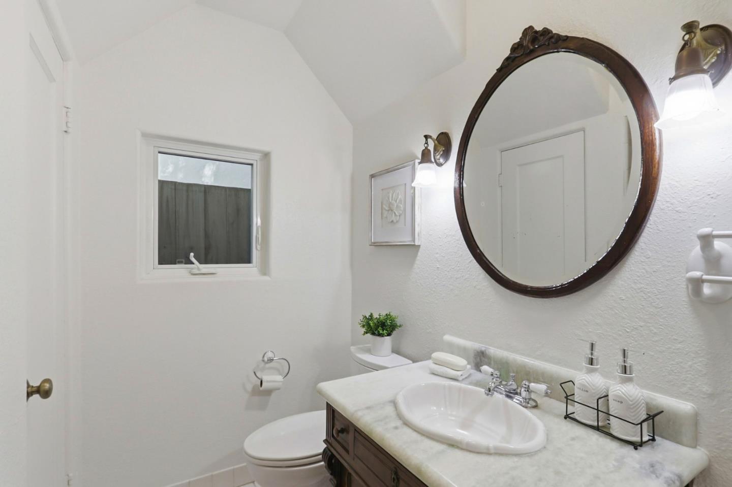 20360 Orchard Road Saratoga, CA 95070 - Photo 27 of 43 a bathroom with a sink and a mirror