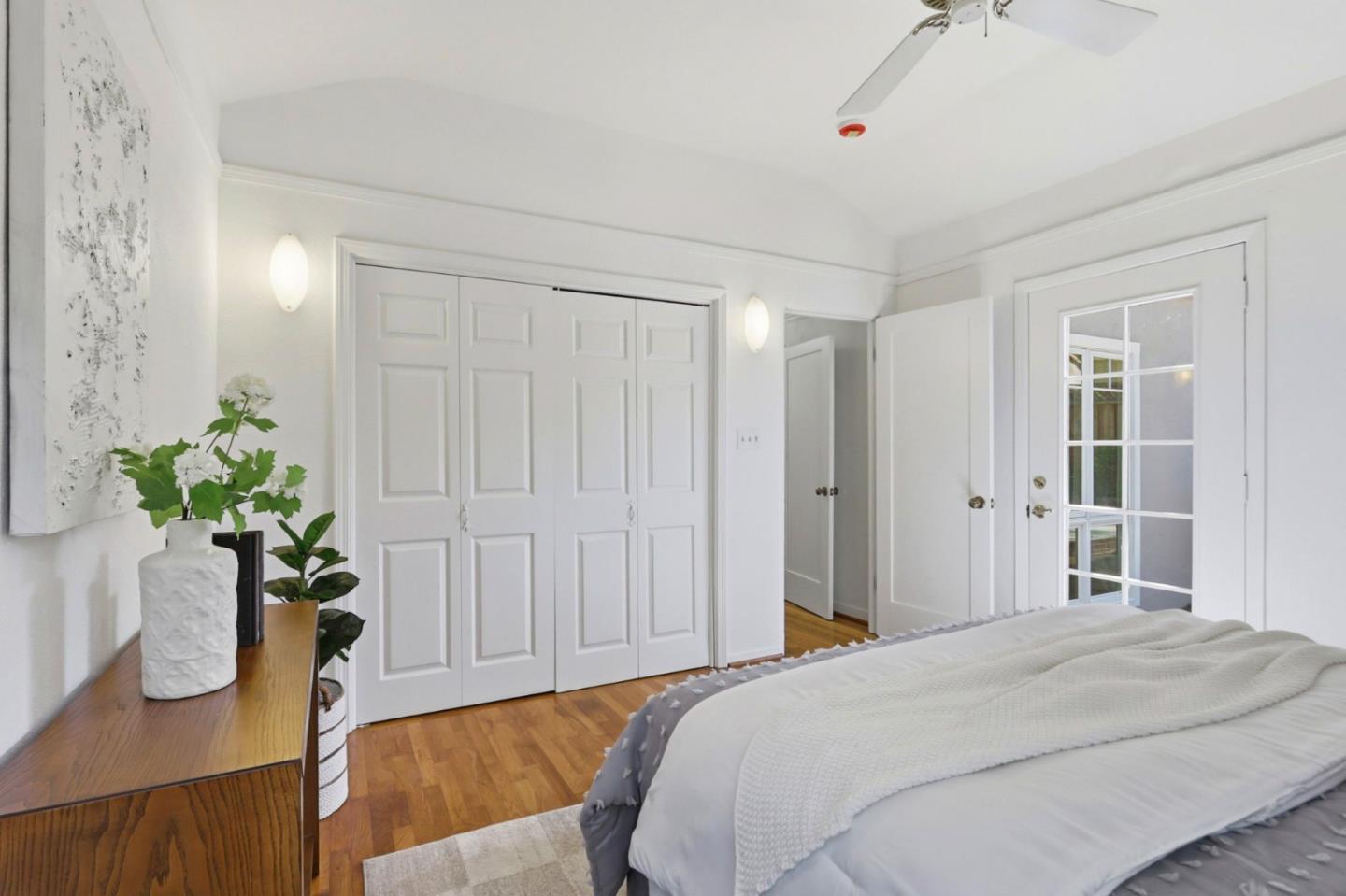 20360 Orchard Road Saratoga, CA 95070 - Photo 30 of 43 a bedroom with a bed table and a potted plant