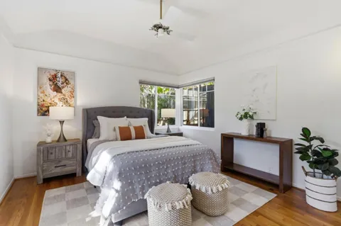 a small barn with a big yard and a large tree