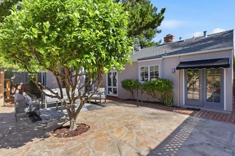 a house view with a sitting space garden and outdoor seating