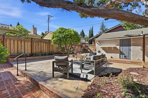 a view of a backyard with sitting area