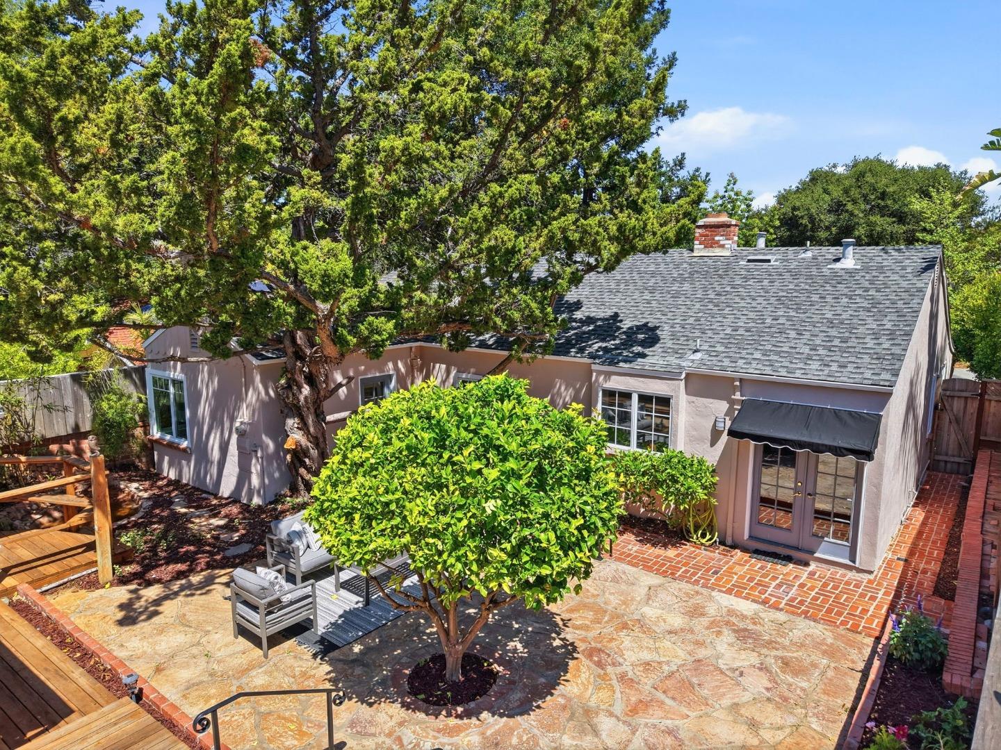 20360 Orchard Road Saratoga, CA 95070 - Photo 39 of 43 a view of a house with brick walls plants and large tree