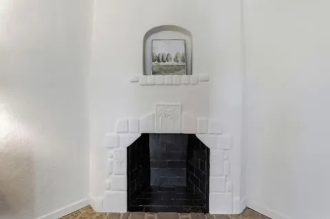 a kitchen with white cabinets and sink