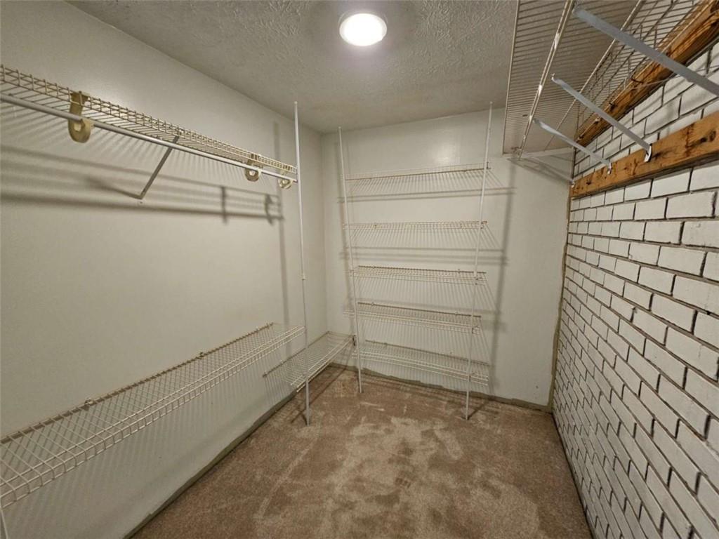1252 Lawrenceville-Suwanee Road Lawrenceville, GA 30043 - Photo 11 of 64 a view of walk in closet with empty racks