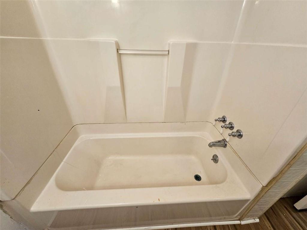 1252 Lawrenceville-Suwanee Road Lawrenceville, GA 30043 - Photo 16 of 64 a bathroom with a bathtub