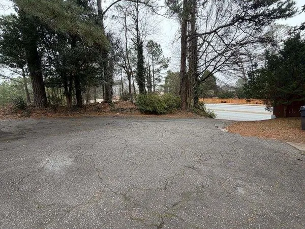 a view of a backyard with large trees