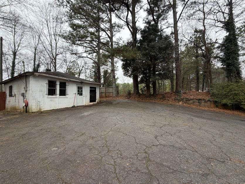 1252 Lawrenceville-Suwanee Road Lawrenceville, GA 30043 - Photo 25 of 64 a view of a house with a large tree and wooden fence