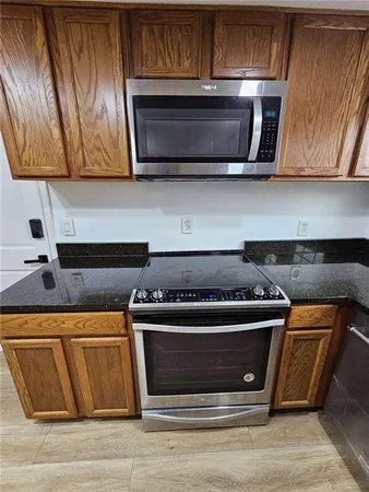a stove top oven sitting inside of a kitchen