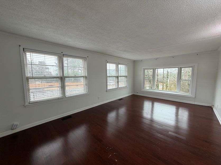 1252 Lawrenceville-Suwanee Road Lawrenceville, GA 30043 - Photo 38 of 64 a view of an empty room with wooden floor and a window