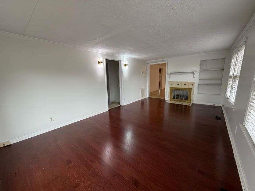 1252 Lawrenceville-Suwanee Road Lawrenceville, GA 30043 - Photo 39 of 64 an empty room with wooden floor and windows