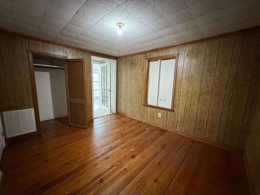 1252 Lawrenceville-Suwanee Road Lawrenceville, GA 30043 - Photo 42 of 64 an empty room with wooden floor and windows