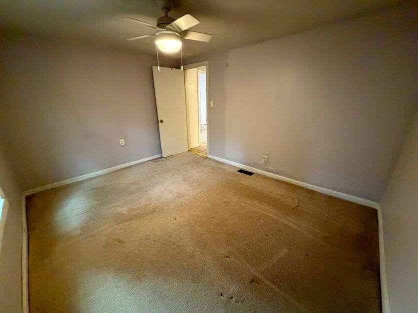 1252 Lawrenceville-Suwanee Road Lawrenceville, GA 30043 - Photo 48 of 64 a view of an empty room with a chandelier fan