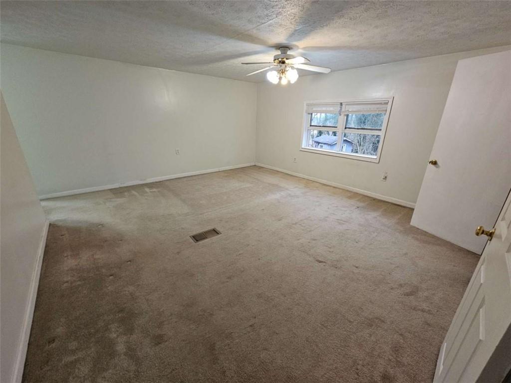 1252 Lawrenceville-Suwanee Road Lawrenceville, GA 30043 - Photo 10 of 64 an empty room with windows and fan