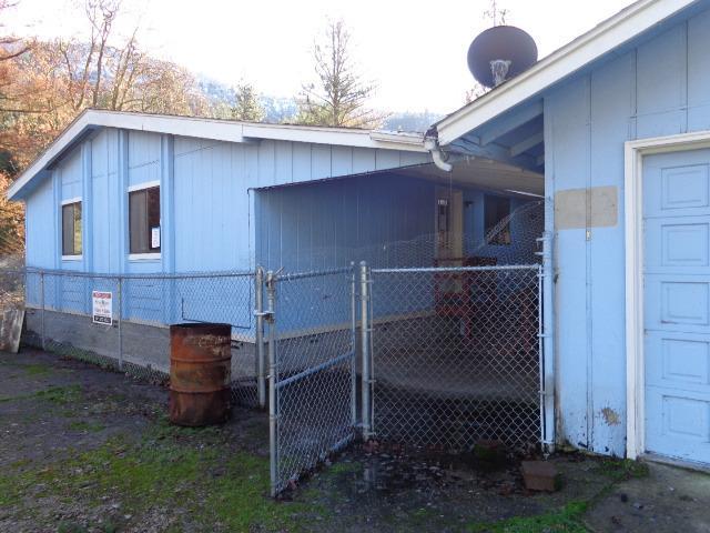 14220 Upper Applegate Road Jacksonville, OR 97530 - Photo 4 of 19 a front view of a house with garden