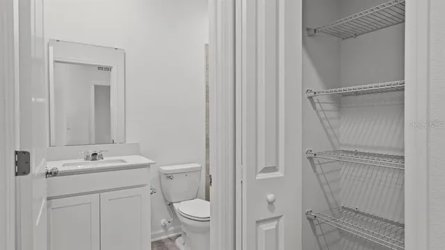 a bathroom with a sink a toilet and a mirror