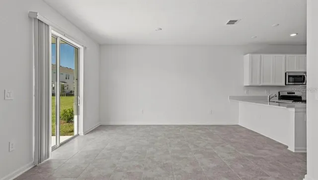 a kitchen with stainless steel appliances a refrigerator a stove a microwave and sink