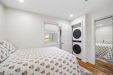 a bedroom with a bed and cabinets with wooden floor