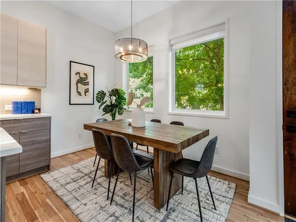 a view of a dining room with furniture window and wooden floor
