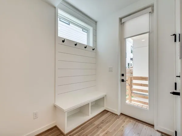 a view of an empty room and wooden floor
