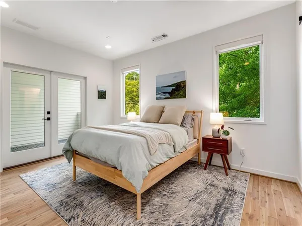 a bedroom with a bed and a window