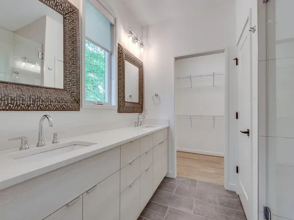 a bathroom with a double vanity sink and a mirror