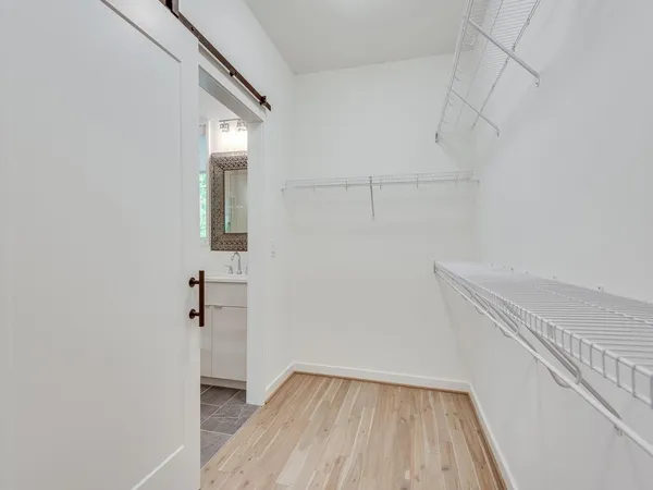a view of a hallway with wooden floor