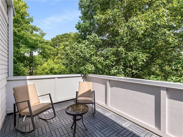a view of balcony with wooden floor and outdoor seating