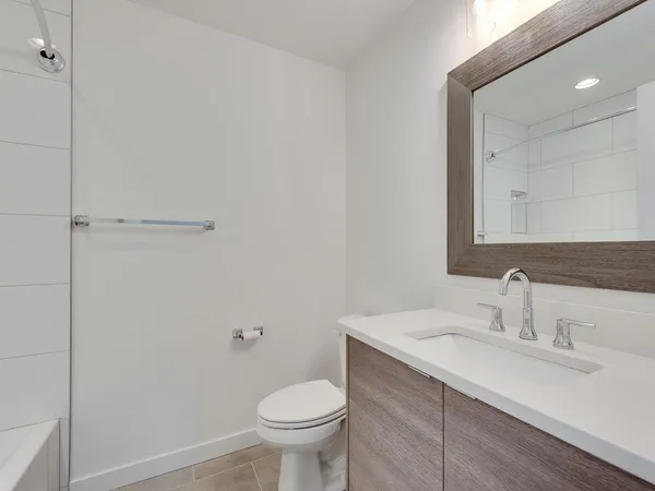 a bathroom with a sink toilet and vanity