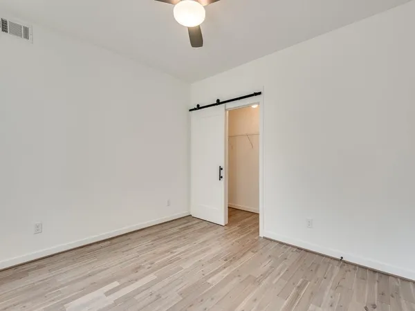 a view of a room with wooden floor