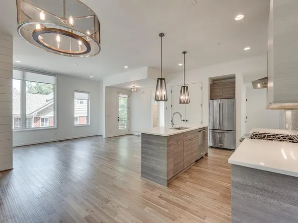 a large white kitchen with a large window