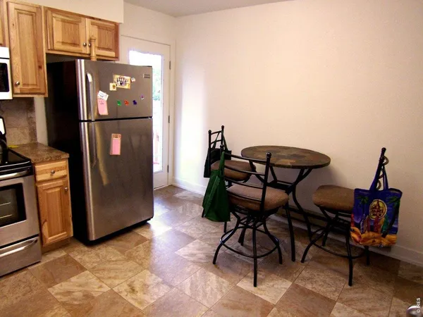 a kitchen with stainless steel appliances a refrigerator a stove a sink dishwasher and a refrigerator