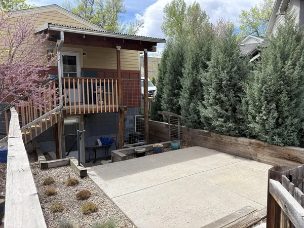 a view of a house with wooden fence