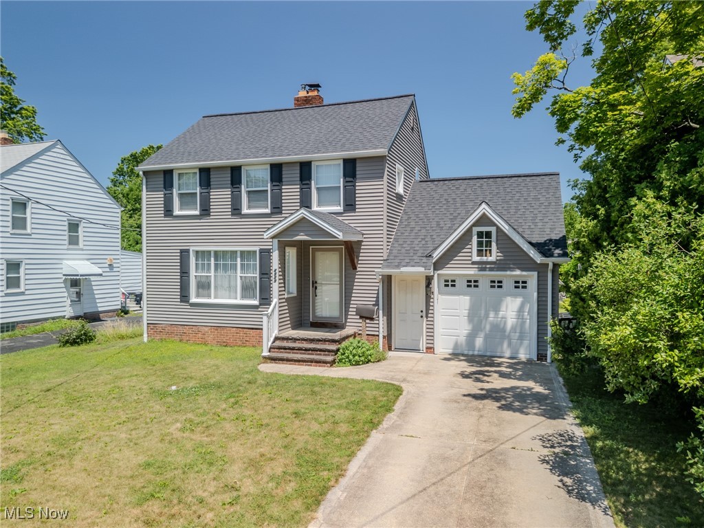 4959 Anderson Road Cleveland, OH 44124 - Photo 2 of 43 Colonial-style house featuring driveway, an attached garage, a chimney, a front lawn, and a shingled roof