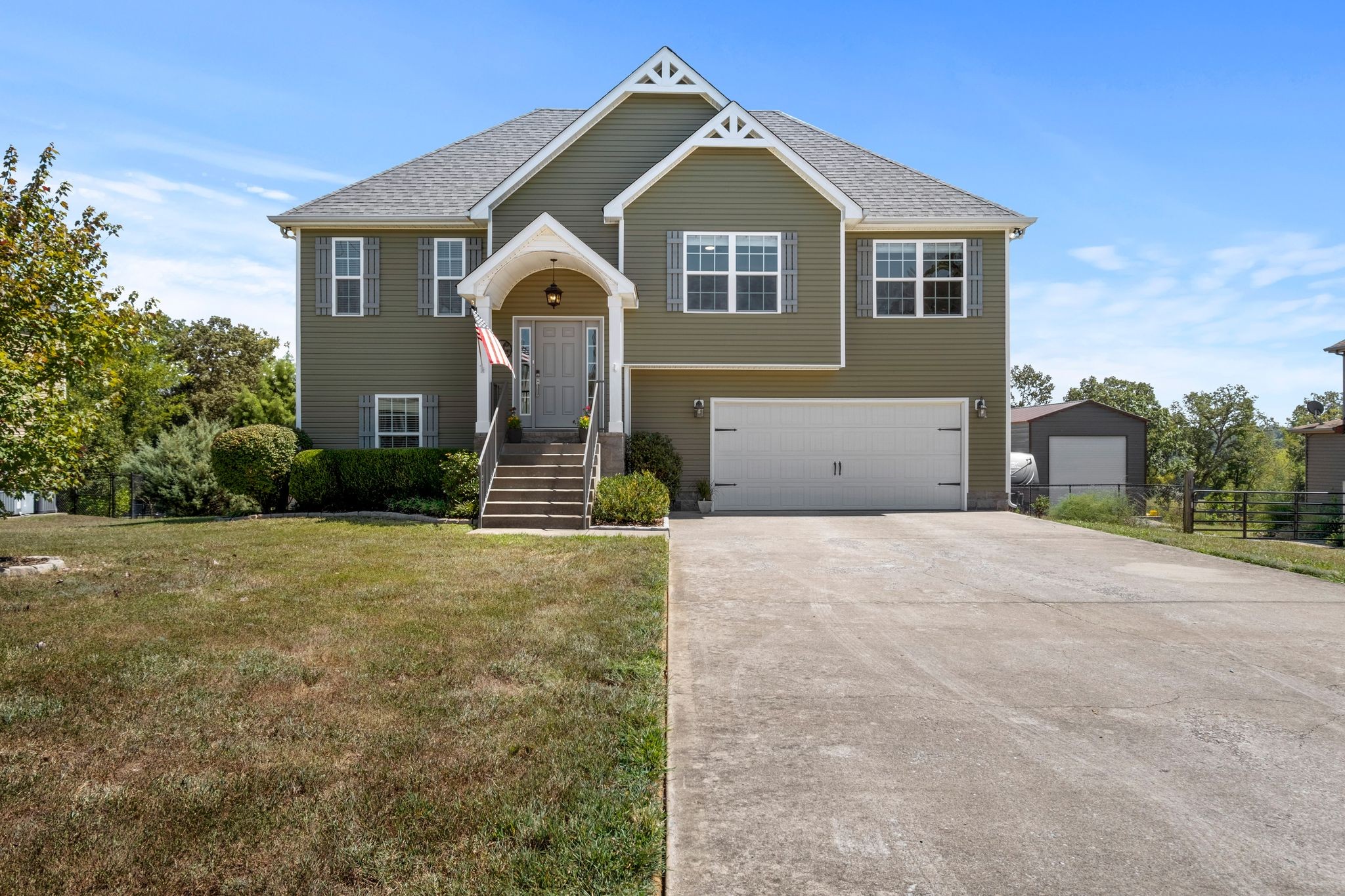 a front view of a house with a yard and garage