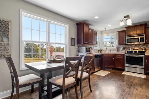a kitchen with a wooden table and chairs